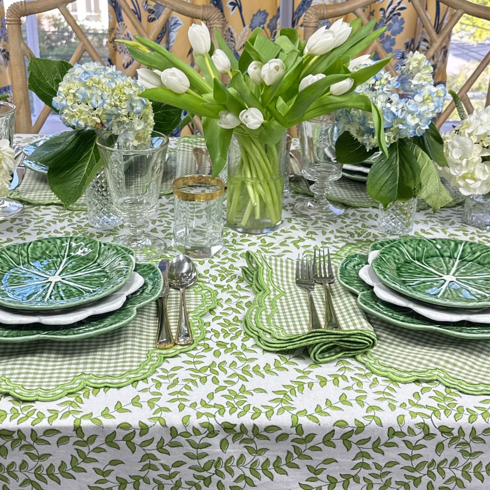 Green Bettina placemat and napkin on green leaves tablecloth with cabbage plates