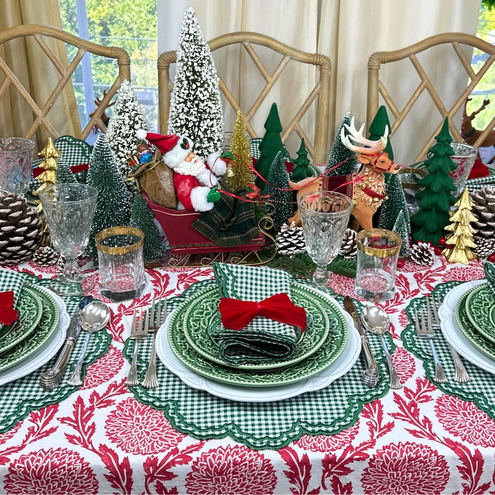 red flower and vine tablecloth and green gingham placemats, red velvet bows, Christmas table