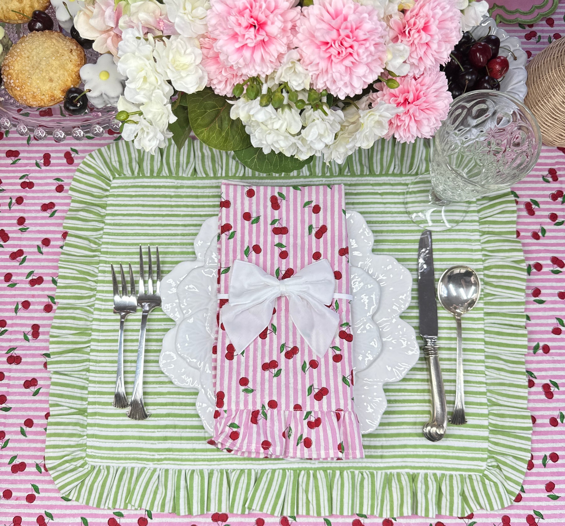 Cherry tablecloth with pink stripes hand block printed with green striped placemat and ruffled matching napkin