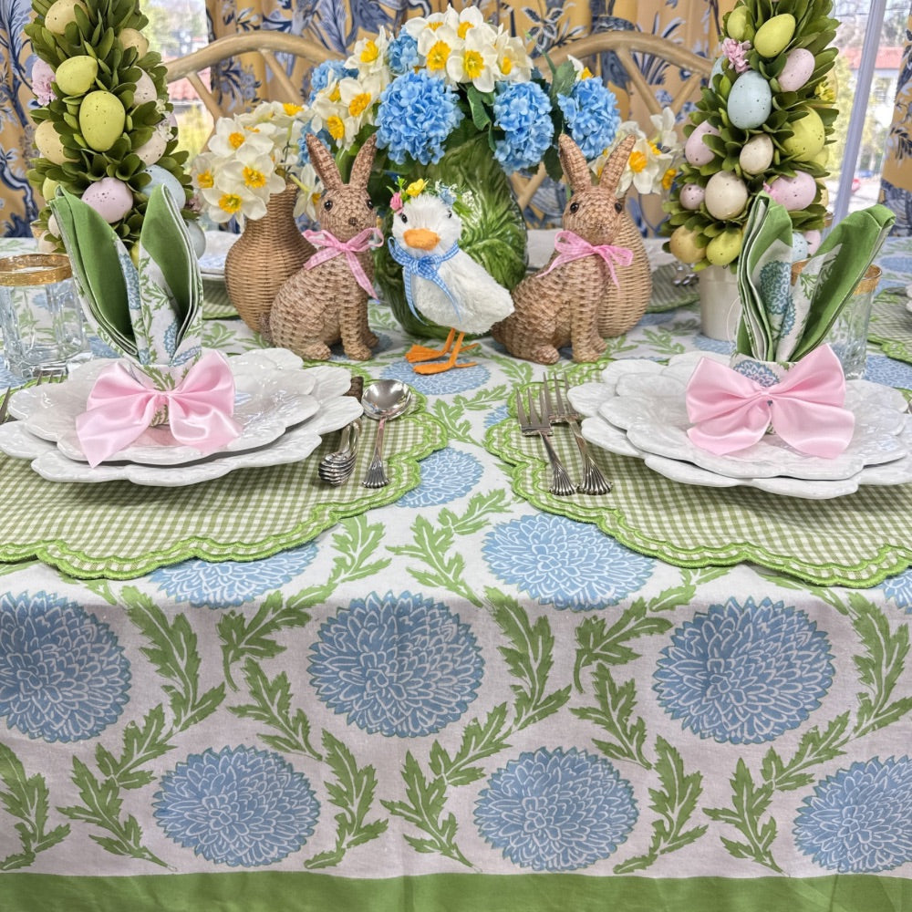 Hand block printed blue and green vines and flowers with luxury embroidered green gingham placemats with pink napkin,bow ties. Napkins are folded like bunny ears.