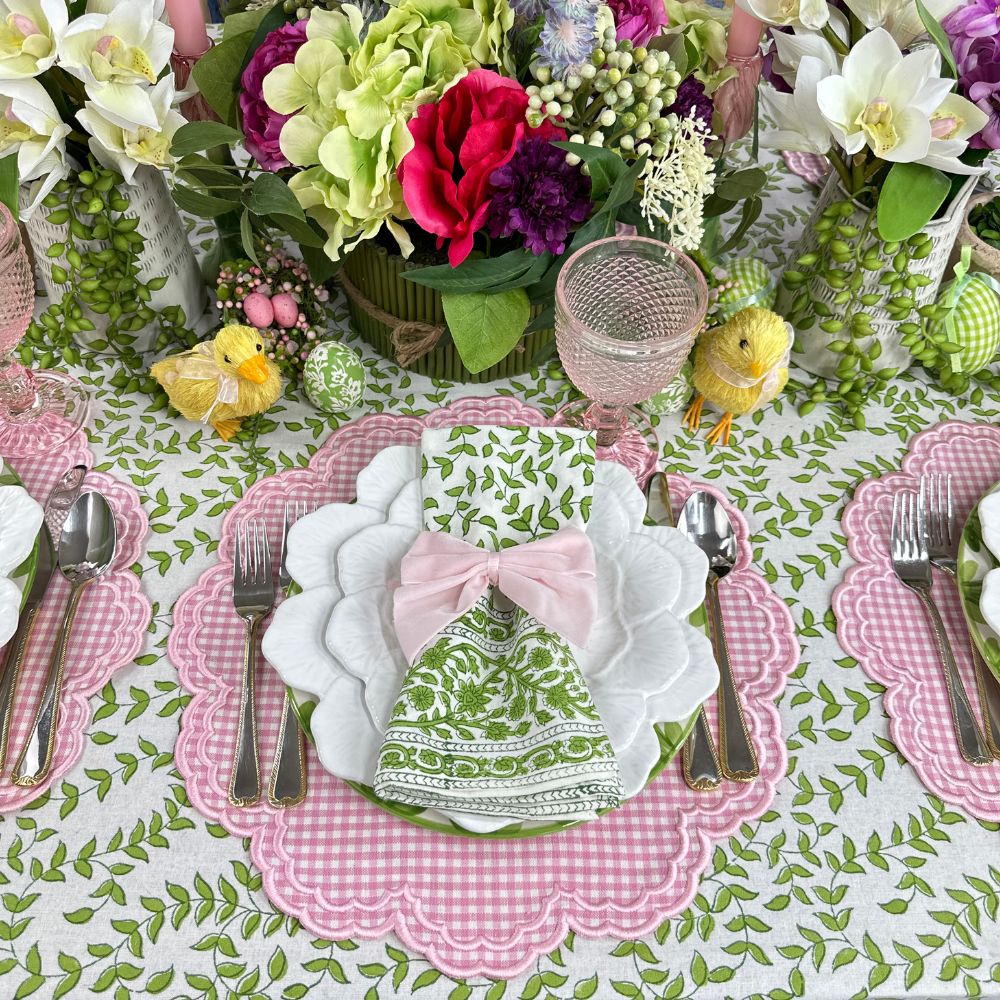 Green leaves tablecloth with pink gingham placemats and napkins